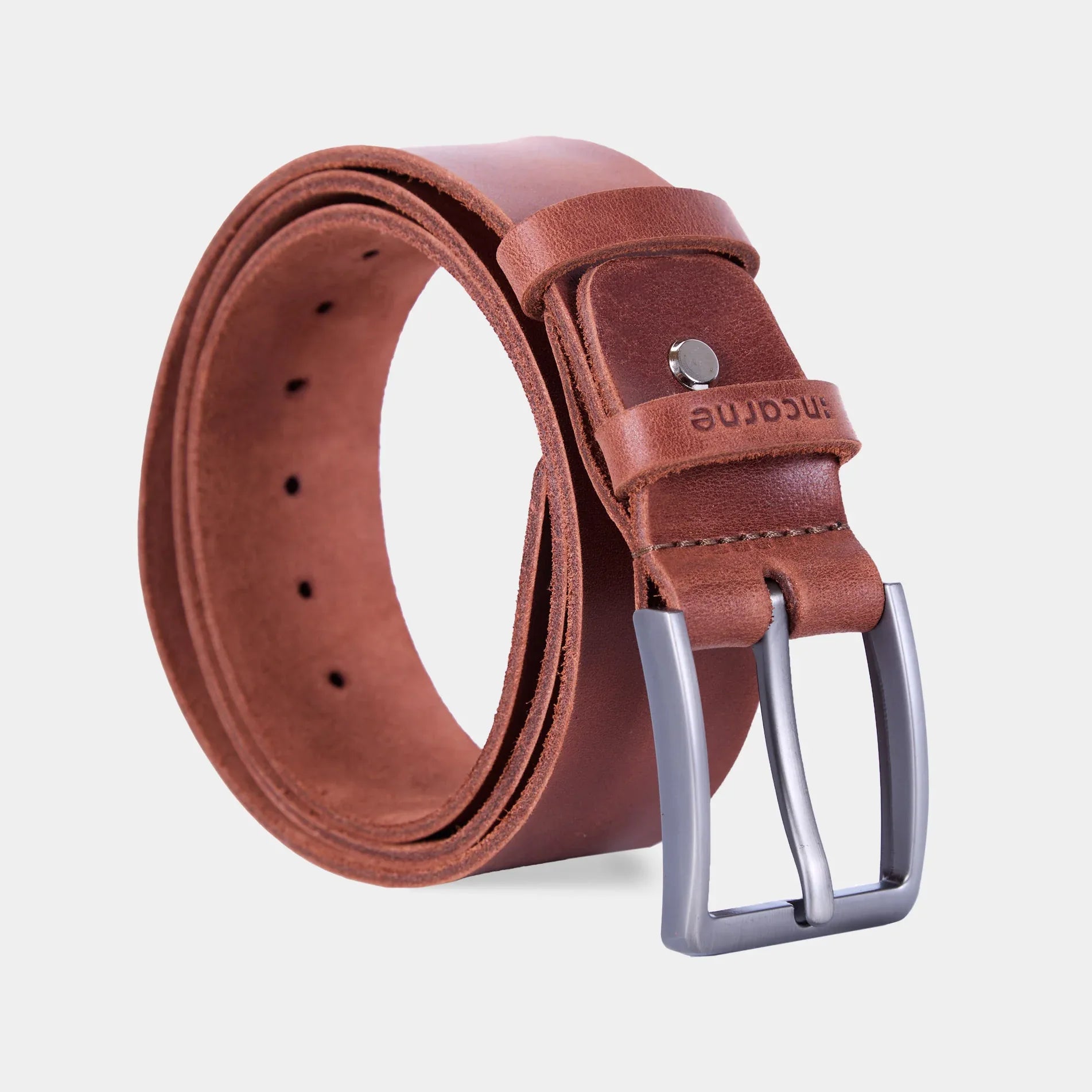 Close up of cognac leather New Parallel belt showing smooth texture and polished metal hardware