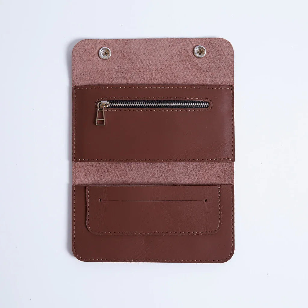 Open leather Roll Master tobacco organizer showing tobacco pouch, paper holder and zip pocket for filters