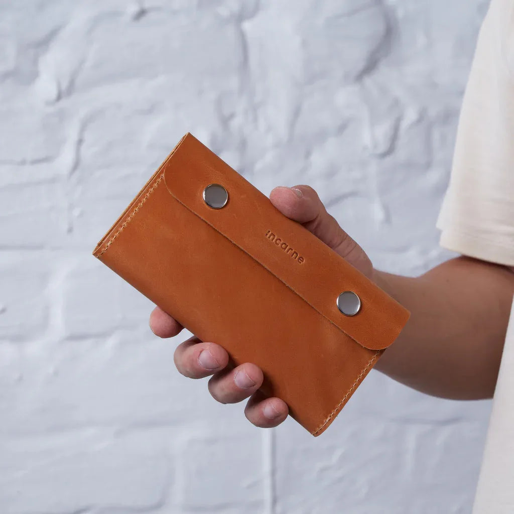 Open cognac leather Roll Master showing tobacco compartment, paper sleeve and zip pocket for filters